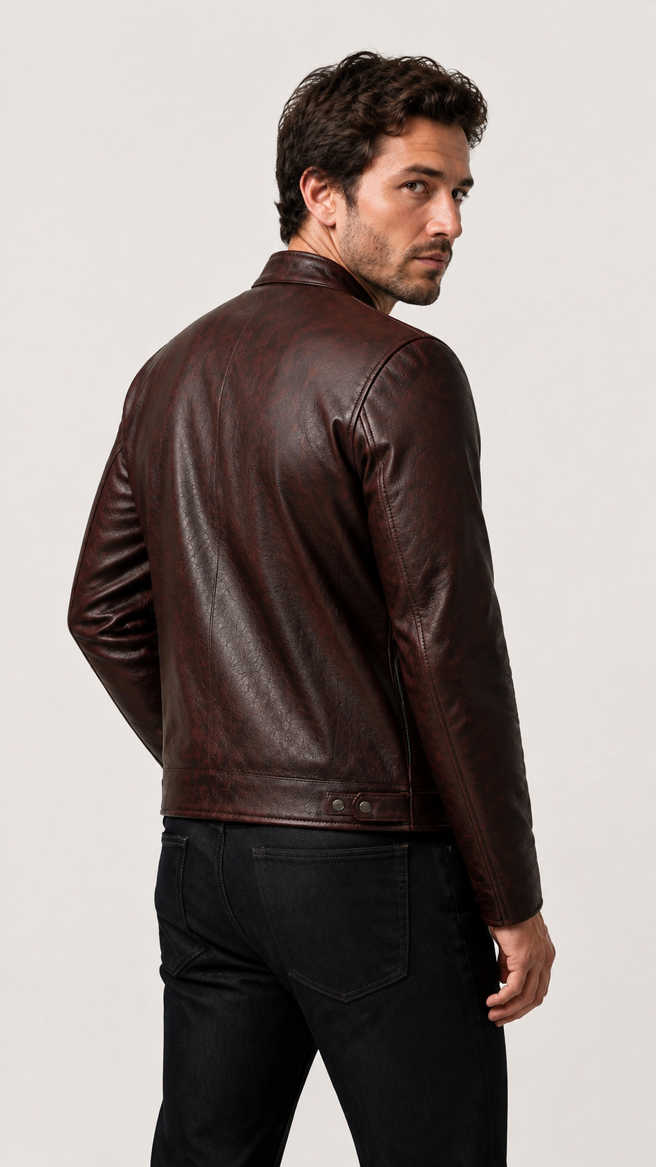 Back view of a man in the oxblood cafe racer jacket with dark jeans — British model